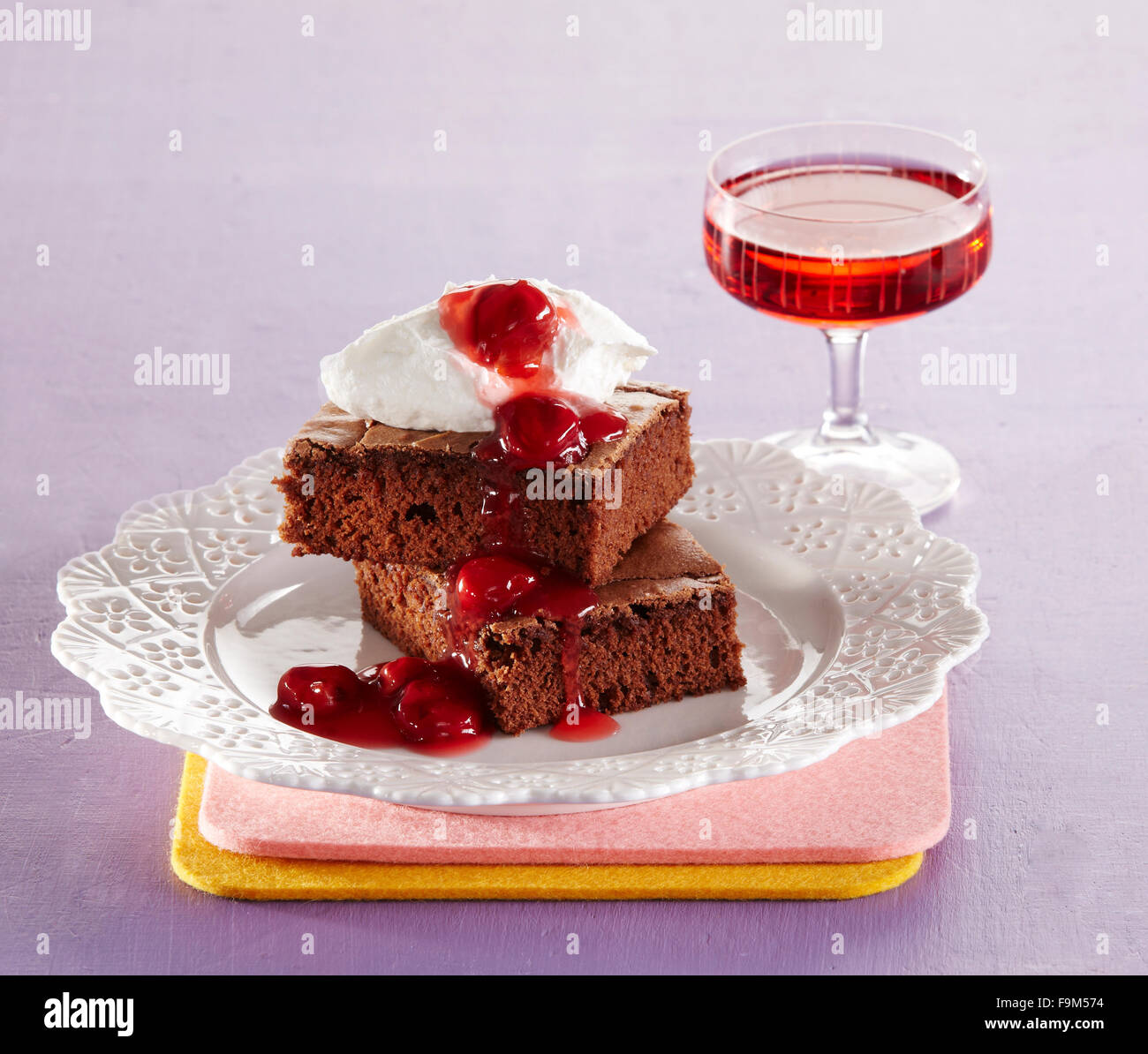 Brownies with cherry brandy sauce Stock Photo Alamy