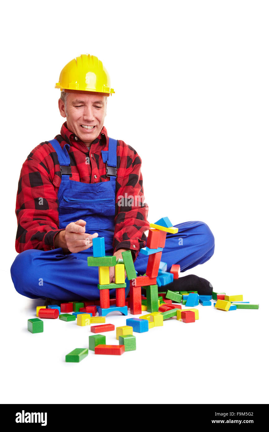 Senior construction worker playing with wood blocks Stock Photo