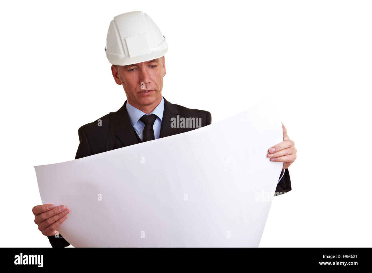 Architect with white helmet looking at construction prints Stock Photo
