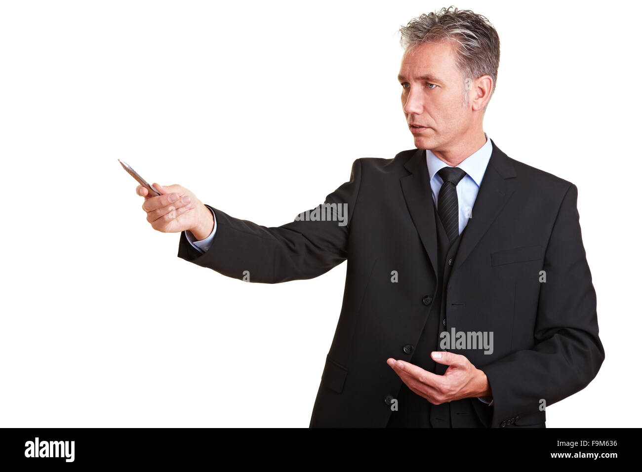 Senior business man in a suit pointing with pen Stock Photo