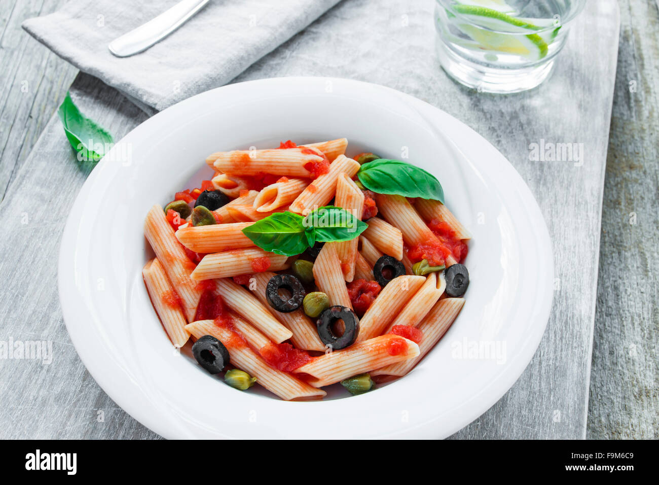 pasta with tomato sauce olives and capers Stock Photo