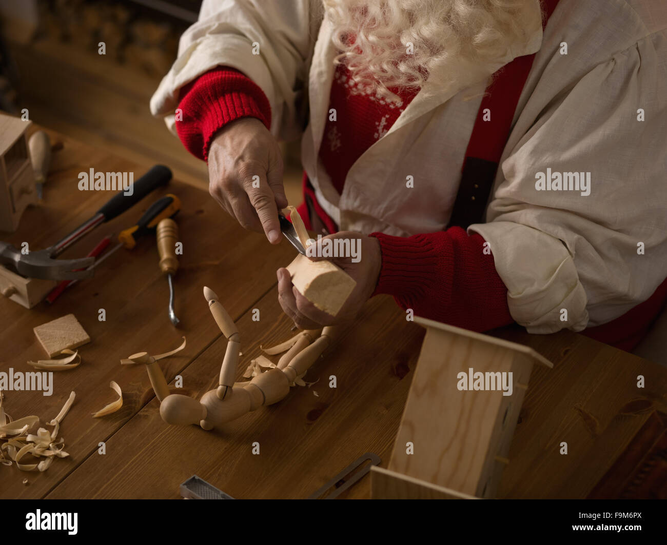 Santa claus working at home making toys for children stock photo alamy