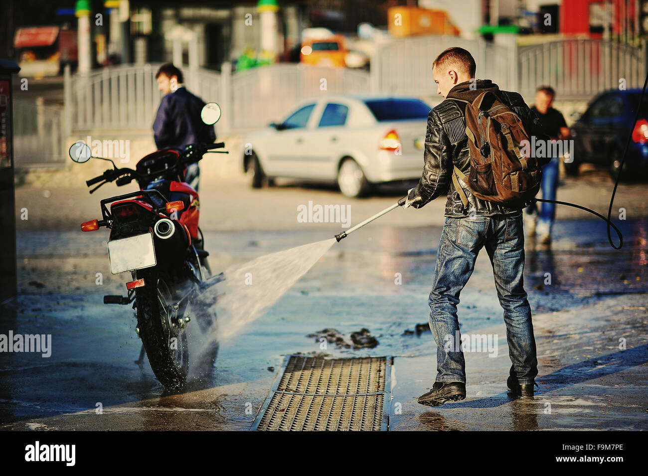 Bike rider washing his motorcycle Stock Photo Alamy