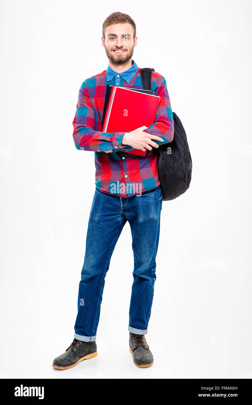 Full length portrait of a happy male student holding books standing ...