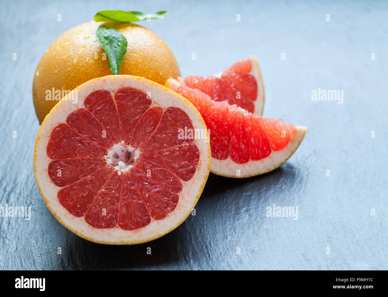 Fresh grapefruit on black stone Stock Photo