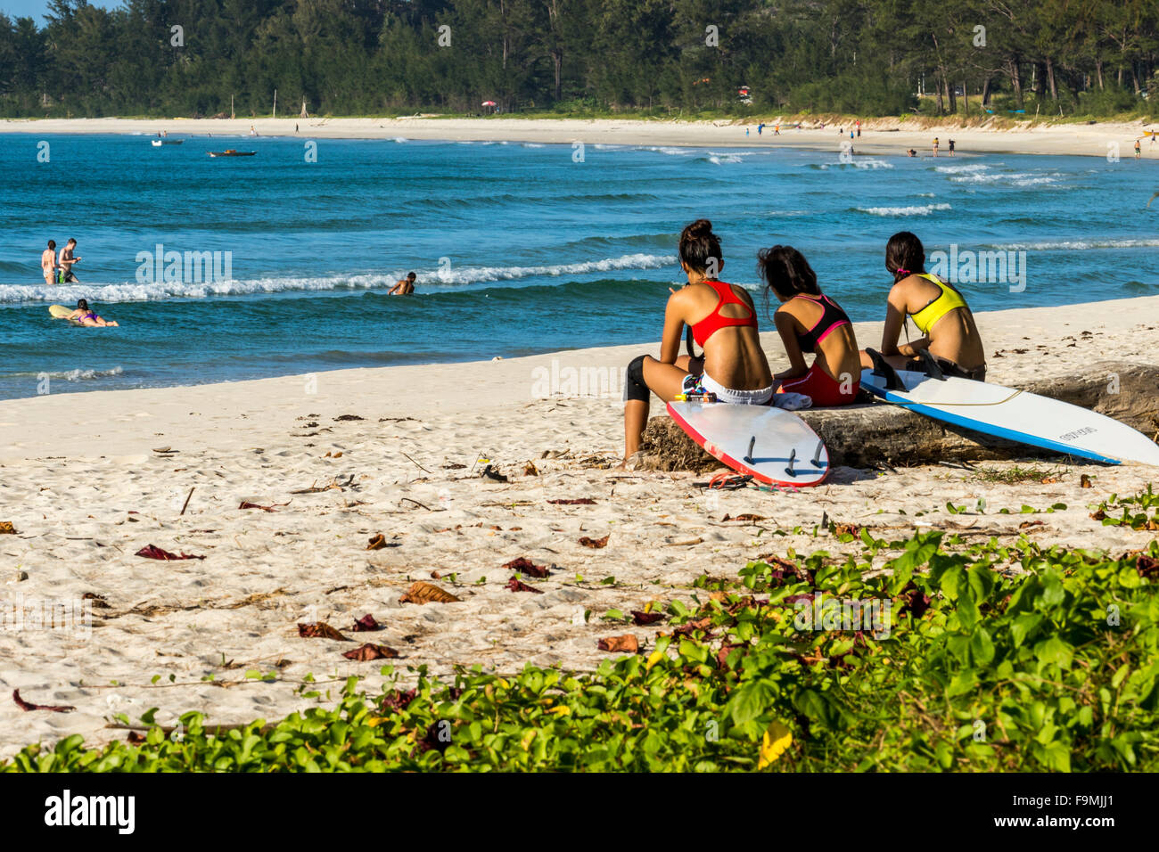 Lady surfers relaxing before going surfing on Tip of Borneo Beach Sabah