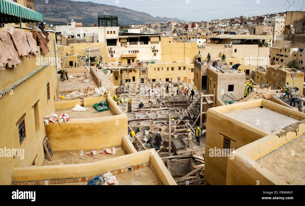Laborers working on rehab and restoration of historic monumet in the Chouwara leather tannery in the Fes El Bali Medina. Stock Photo