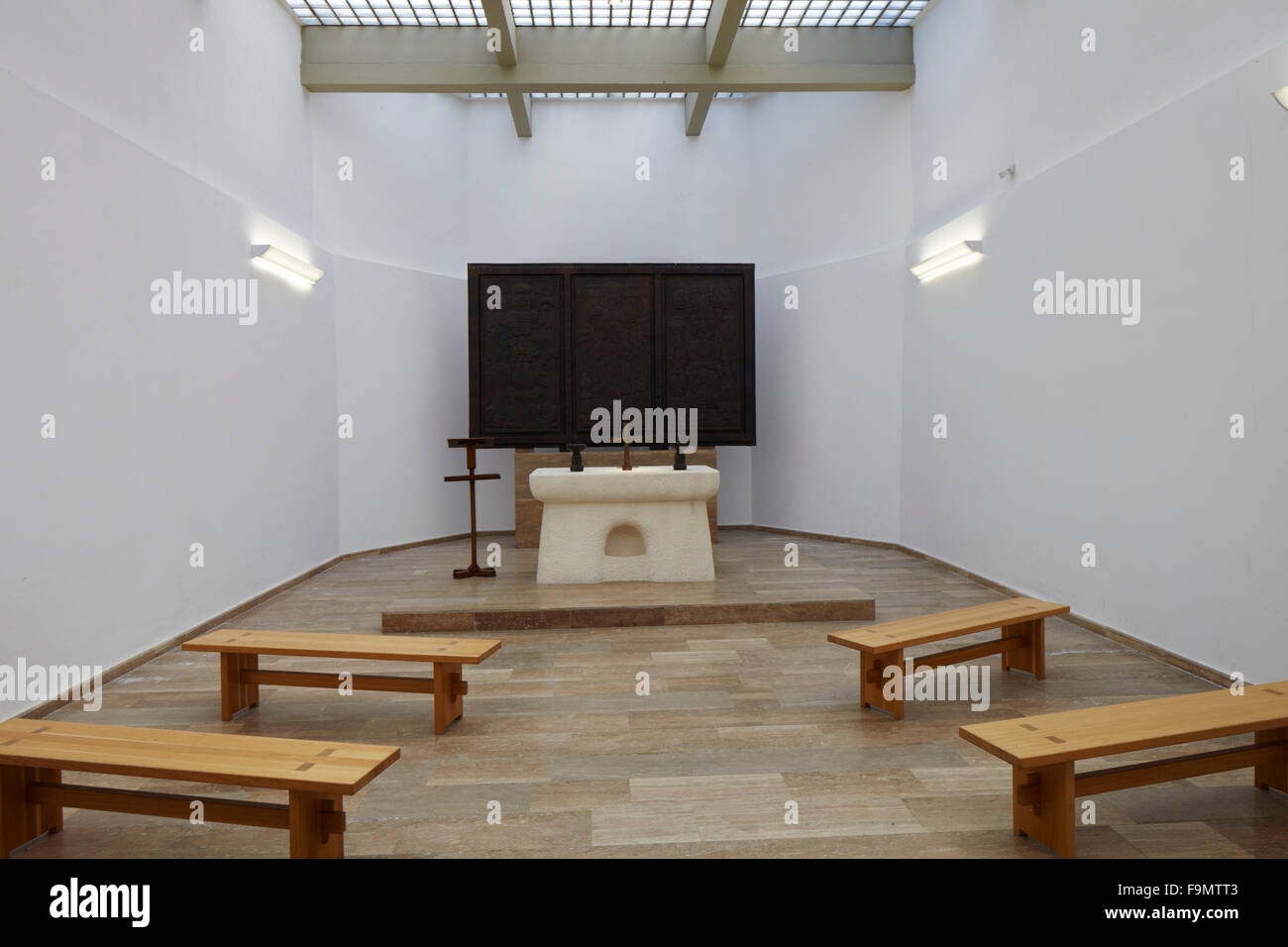 Altar and triptych by artist Rudolf Kedl. The simple white painted interior of the chapel with benches at Battle of Mogersdorf  Memorial Chapel Schloesselberg, Mogersdorf, Austria Stock Photo