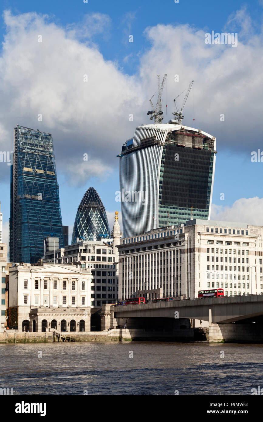 The Swiss Re Insurance building, also known as 'the Gherkin', stands between an almost completed Leadenhall building 'the Cheesegrater', left, and a nearly completed 20 Fenchurch Street, or the 'Walkie-Talkie', right, as seen from the South Bank of the Th Stock Photo
