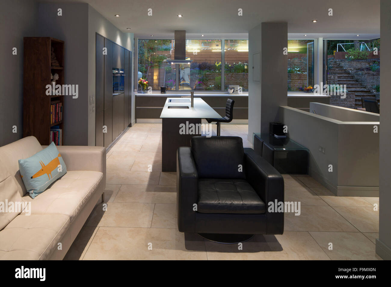 Open plan living area looking through to the kitchen and garden.  A modern family home. Stock Photo