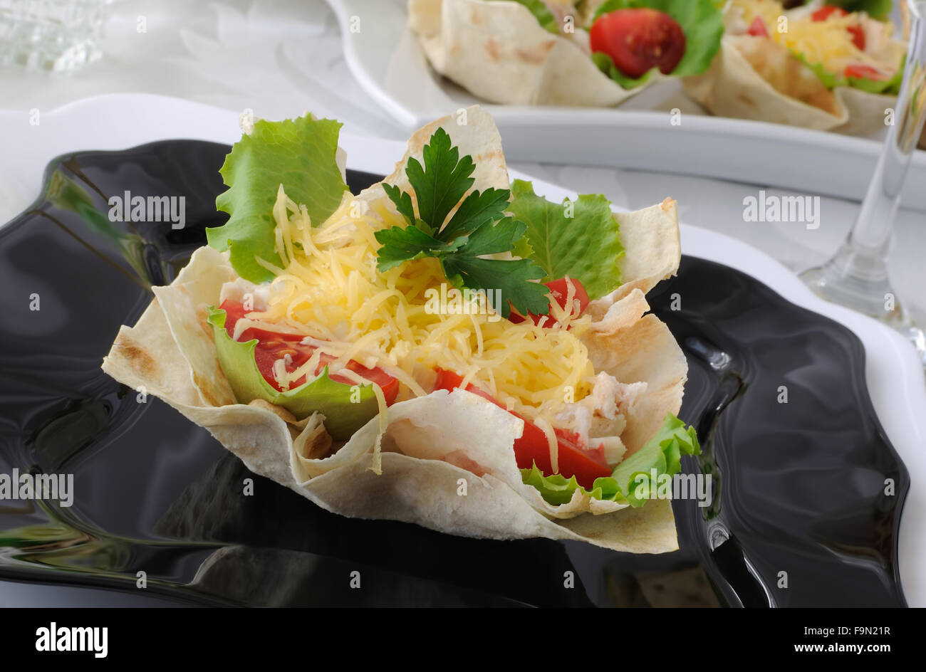 Chicken with tomatoes and cheese in a basket made of dough 'phyllo' Stock Photo