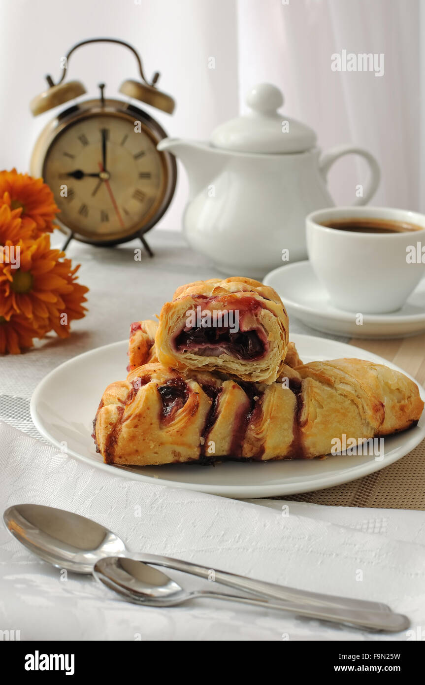 A piece of strudel with cherries with a morning cup of coffee Stock Photo
