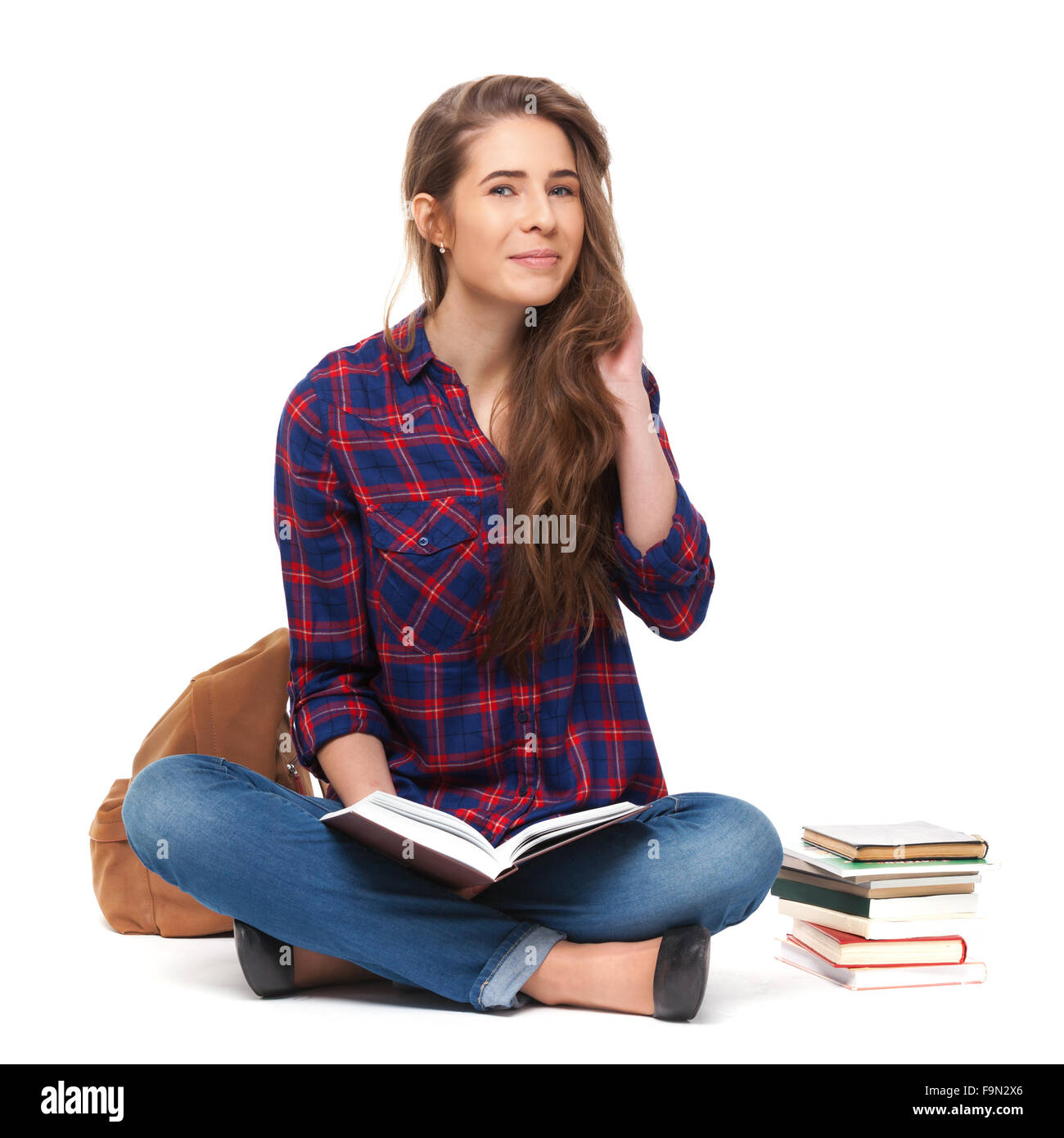 Portrait of happy female student reading a book isolated on white. Stock Photo