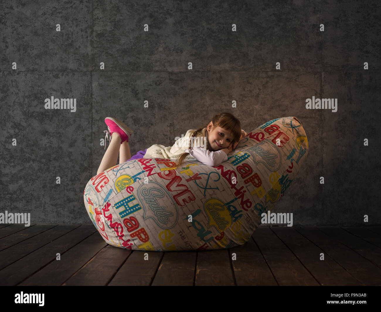 Girl Resting on Beanbag at home Stock Photo - Alamy