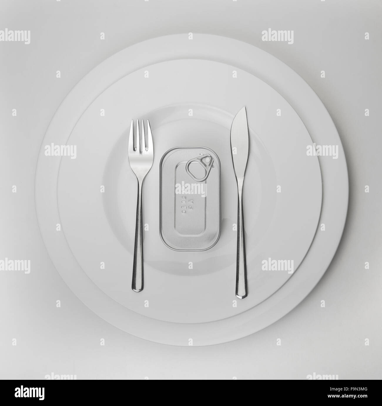 canned fish on an elegant plate – what's left after the financial crises Stock Photo