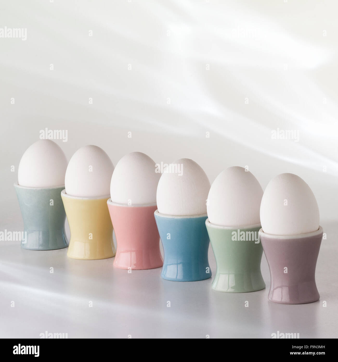 eggs in eggcups in a row Stock Photo