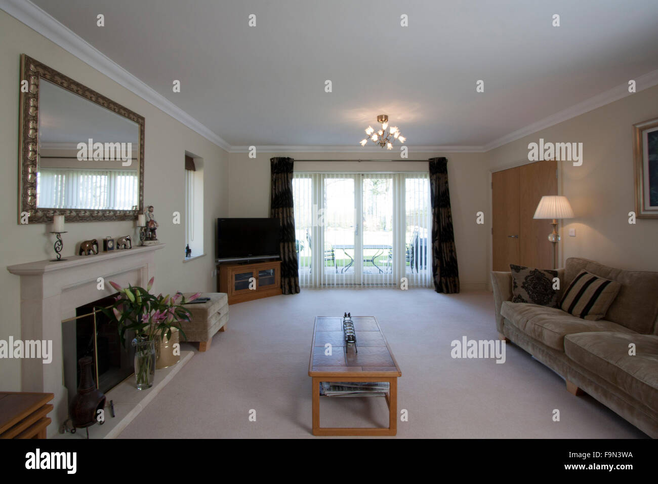 Large Lounge With A Sofa Coffee Table Fireplace And Double Doors