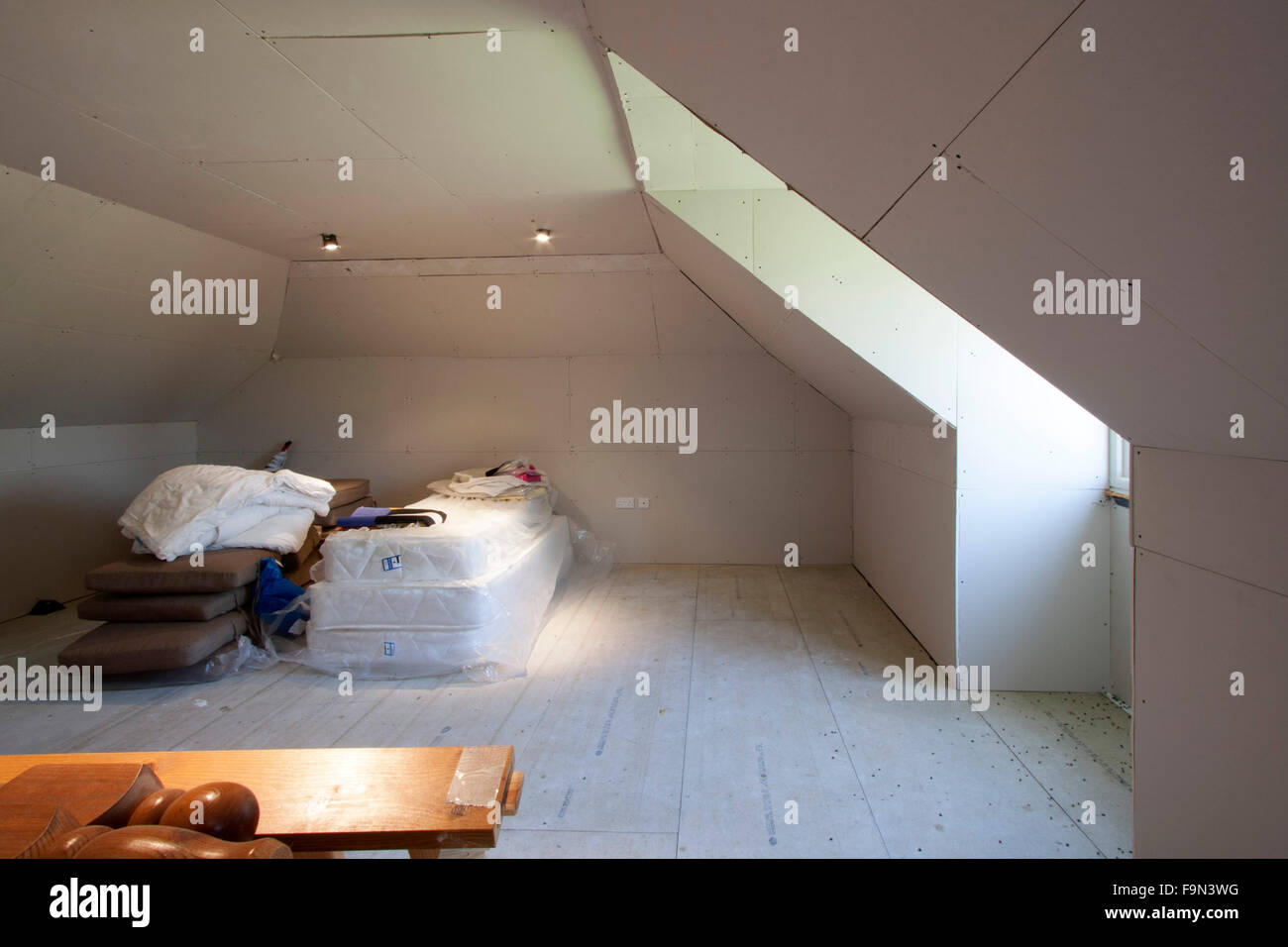 Loft with mattresses and bed frames and storage space Stock Photo