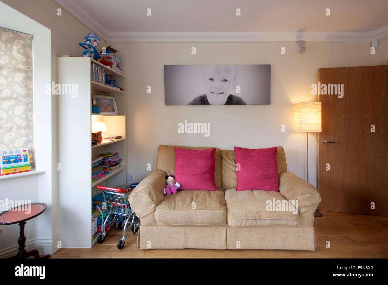 Children's play room with toys and a sofa Stock Photo