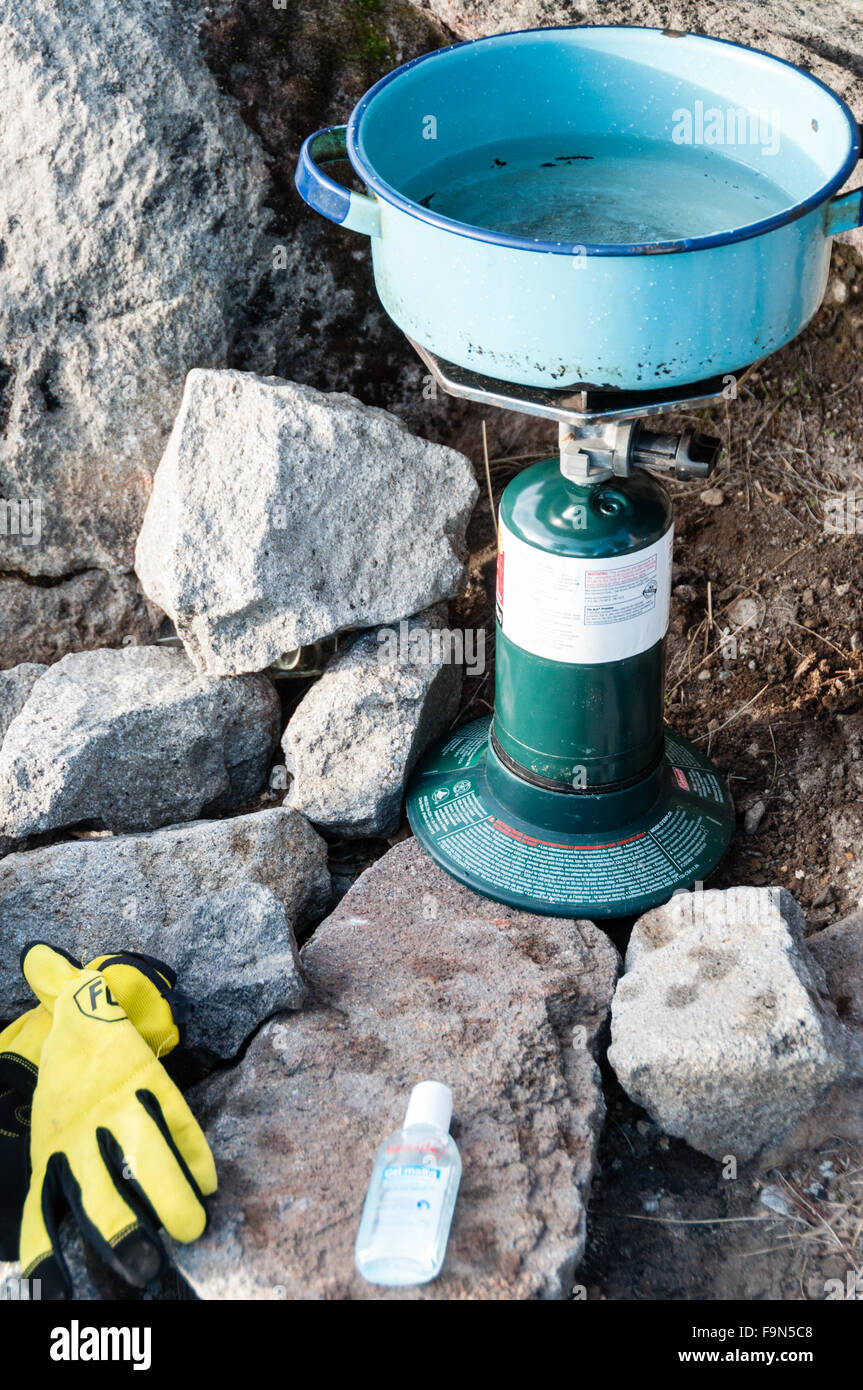 Boilling Rocks Boiling Water with camping stove amidst big Rocks and stones in The ...