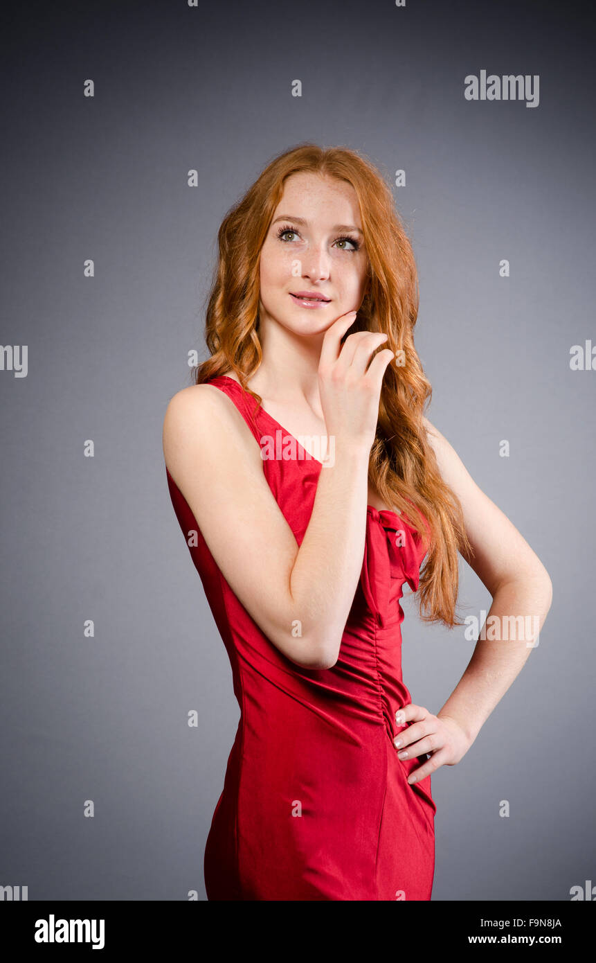 Girl in red dress against gray Stock Photo Alamy