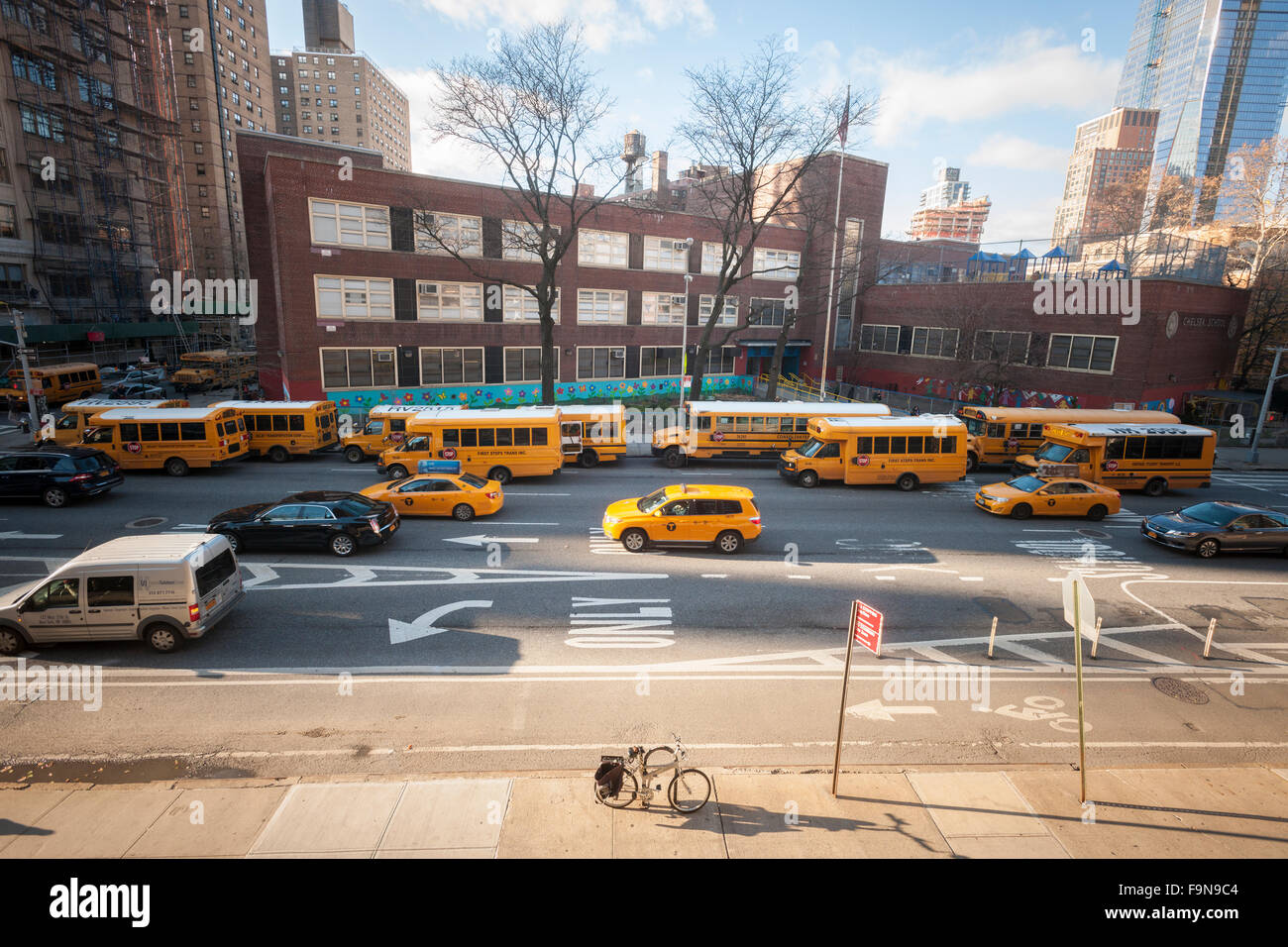 School buses line up in front of PS 33 in Chelsea in New York on Tuesday, December 15, 2015 for normal dismissal of the students. A bomb threat deemed to be a hoax was sent to the NY Dept. of Education and to the Los Angeles Unified School District. LA closed all of its schools effecting 640,000 students while NY kept the schools open with normal dismissal times. (© Richard B. Levine) Stock Photo