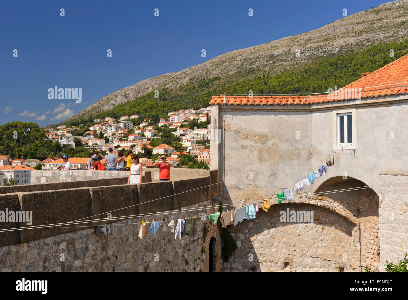 People walking along the perimeter of the old fortress, Dubrovnik, Croatia. Stock Photo