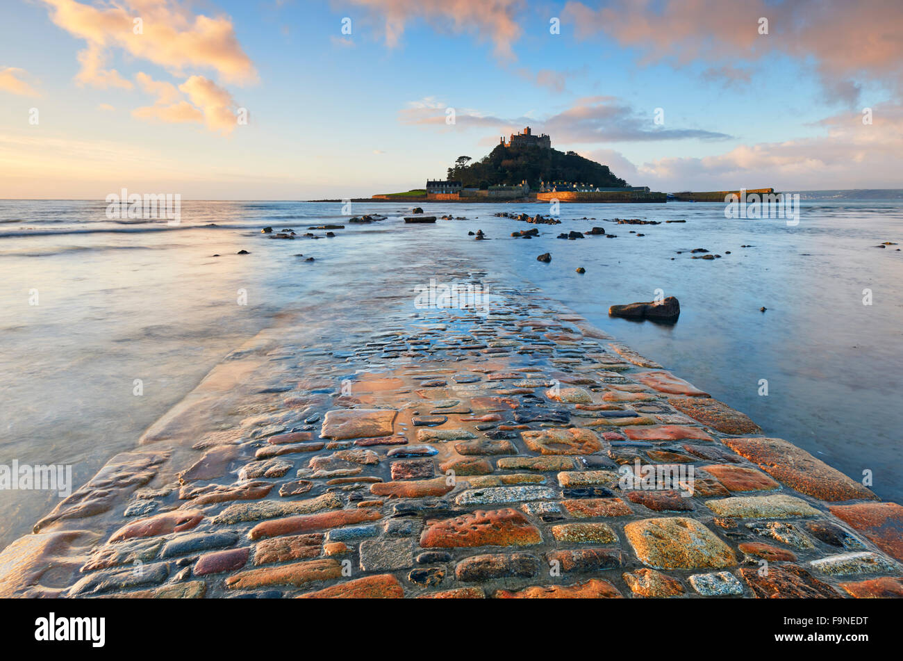The receding tide reveals a view of the cobbled causeway that connects St Michael's Mount with the mainland Stock Photo
