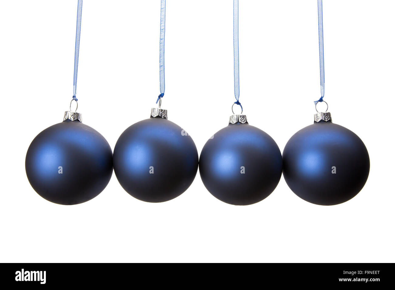 Four blue christmas baubles hanging in horizontal row isolated on white background Stock Photo