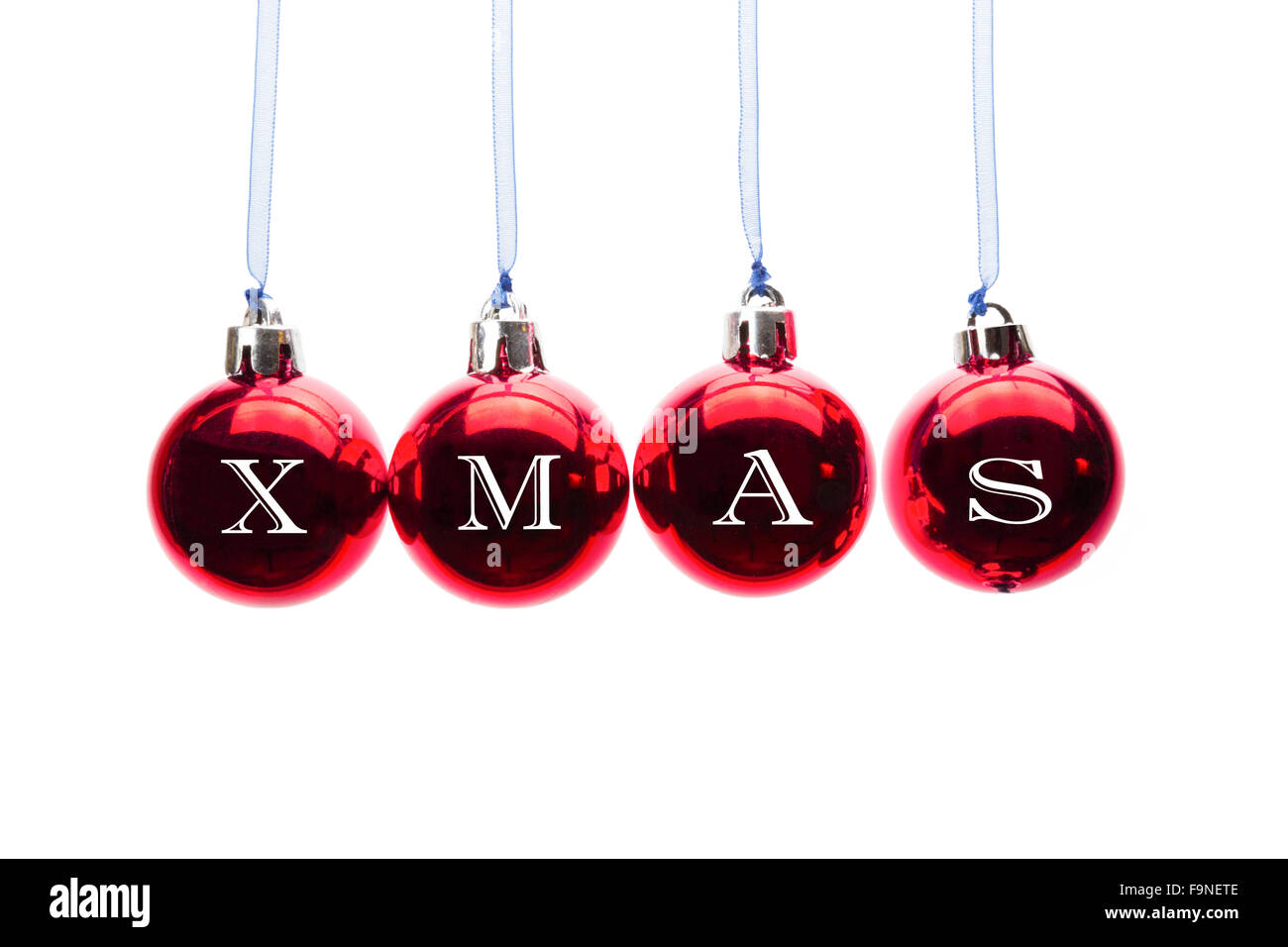 Word XMAS on red christmas balls hanging in a horizontal row isolated on white background Stock Photo