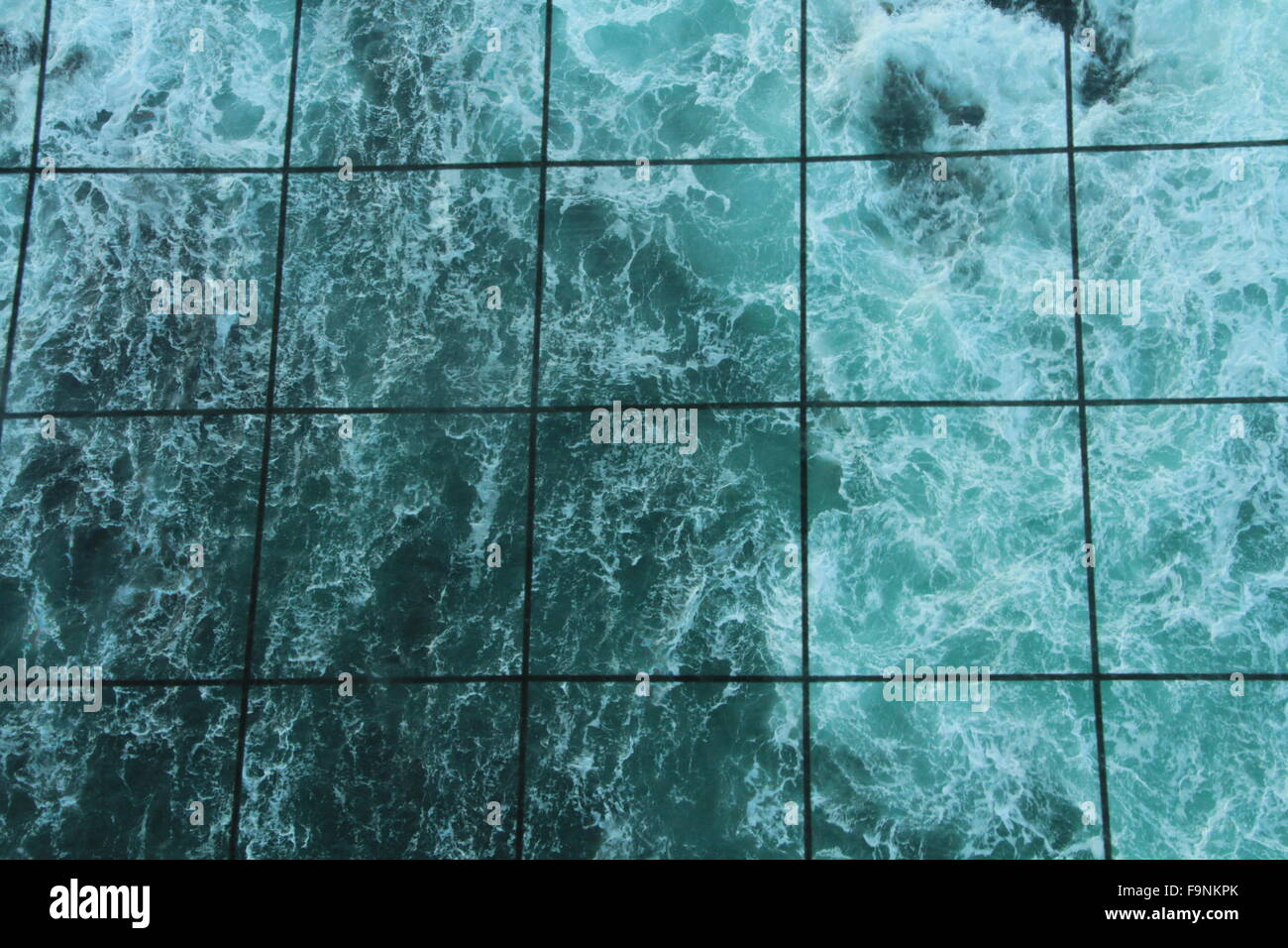 swirling sea through grid Stock Photo