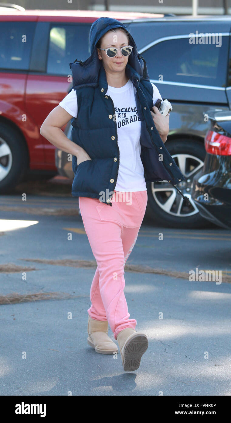 Kaley Cuoco wearing peach 'Happiness' jogging pants with brown Ugg boots  together with a sleeveless padded hoodie and a t-shirt with a 'Mercury is  in retrograde' logo, grabs a sandwich at Ralph's