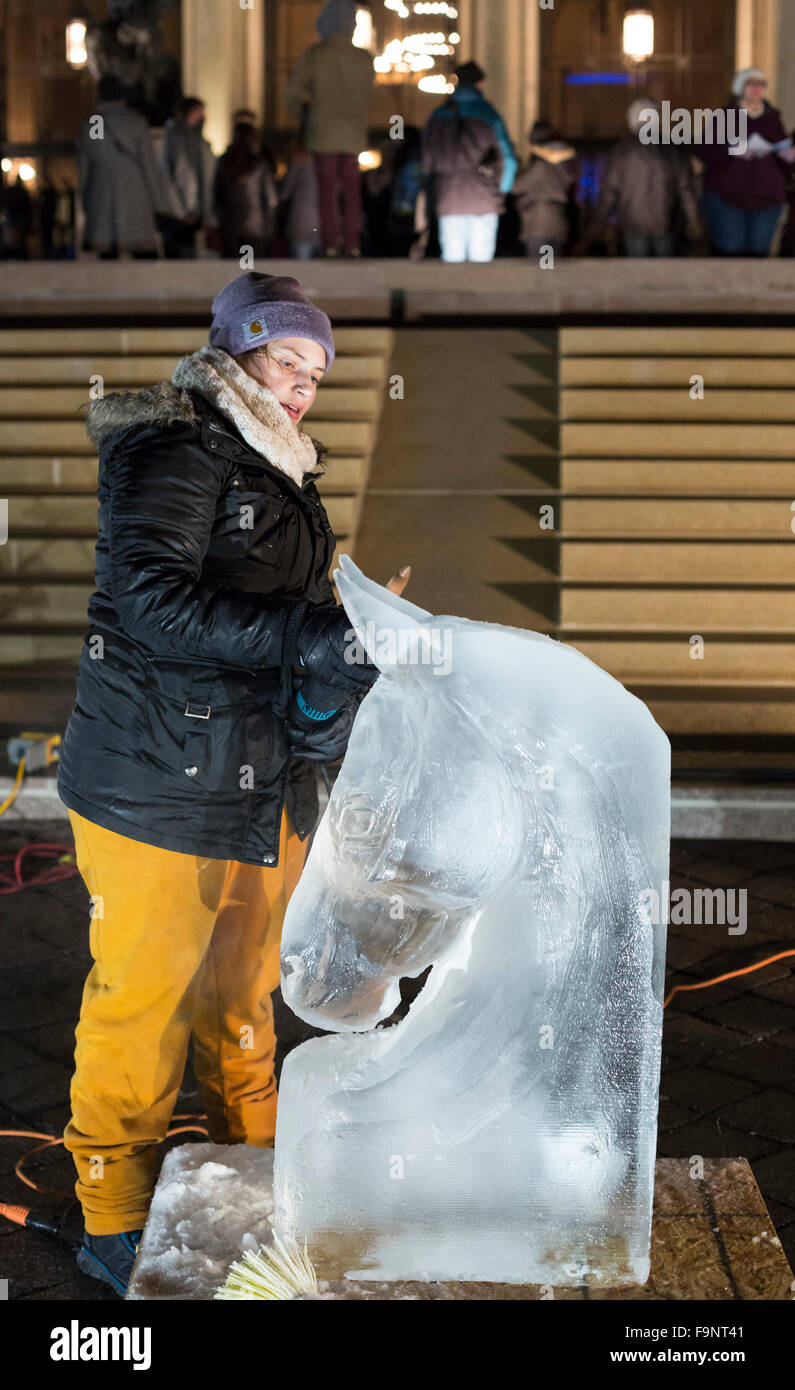Detroit, Michigan - An artist makes an ice sculpture in front of the Detroit Institute of Arts during Noel Night. Stock Photo