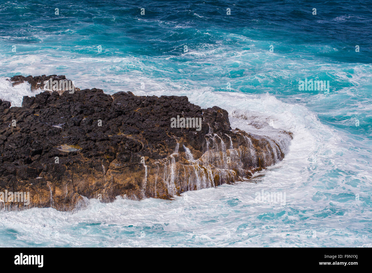 Waves breaking hard on a rock at Phillip Island, Victoria, Australia Stock Photo
