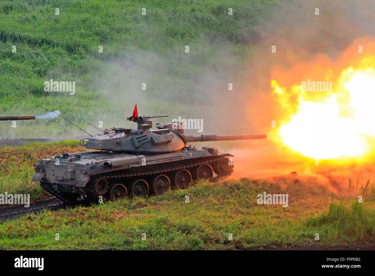 The type 74 Tank of JGSDF  is firing 105 mm cannon Stock Photo