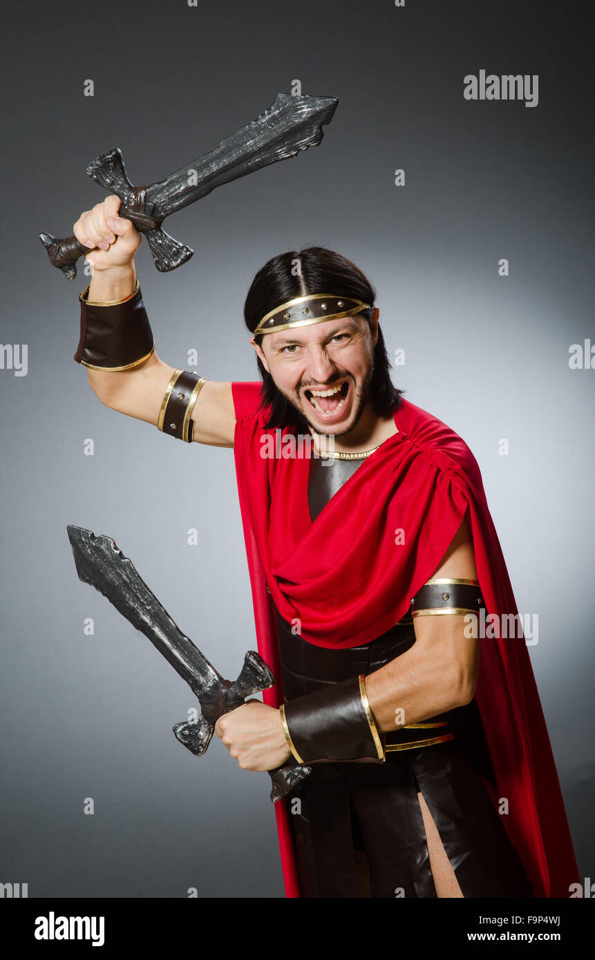 Roman warrior with sword against background Stock Photo - Alamy