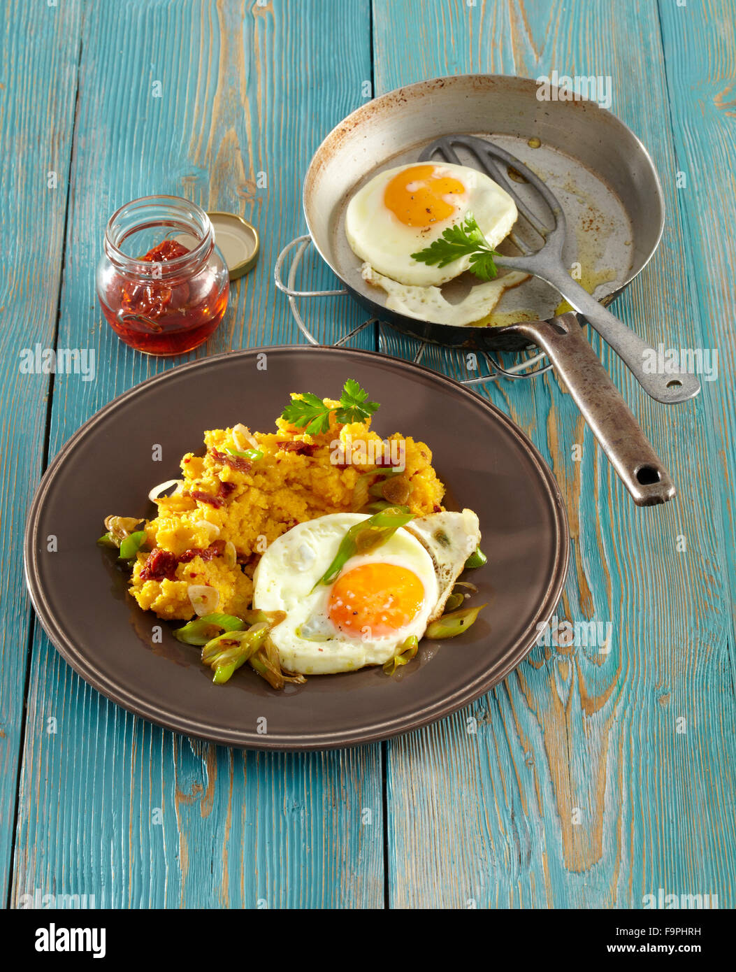 Dried tomato polenta with fried egg Stock Photo Alamy