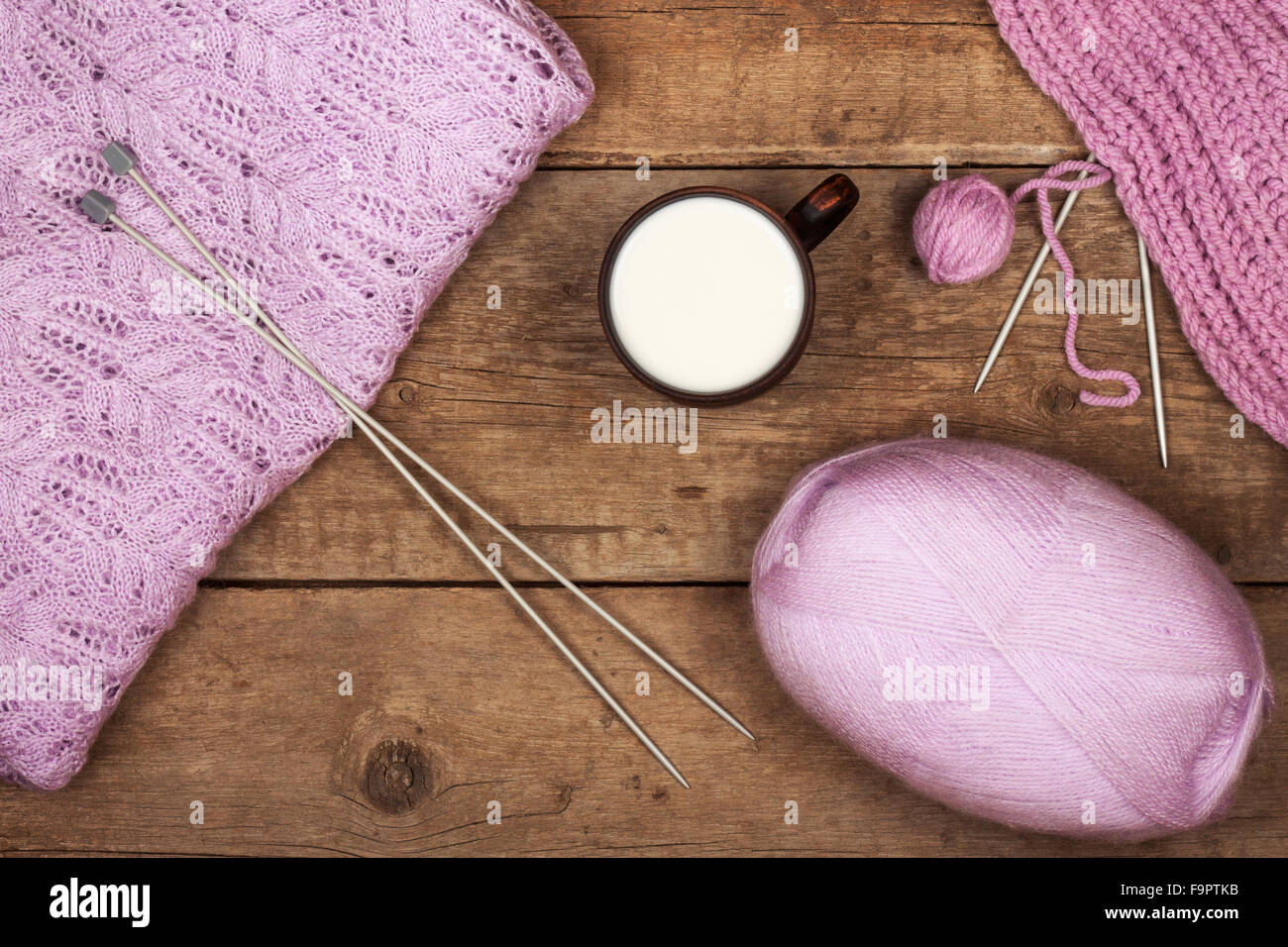 Women's delicate purple sweater with a cup of warm milk Stock Photo