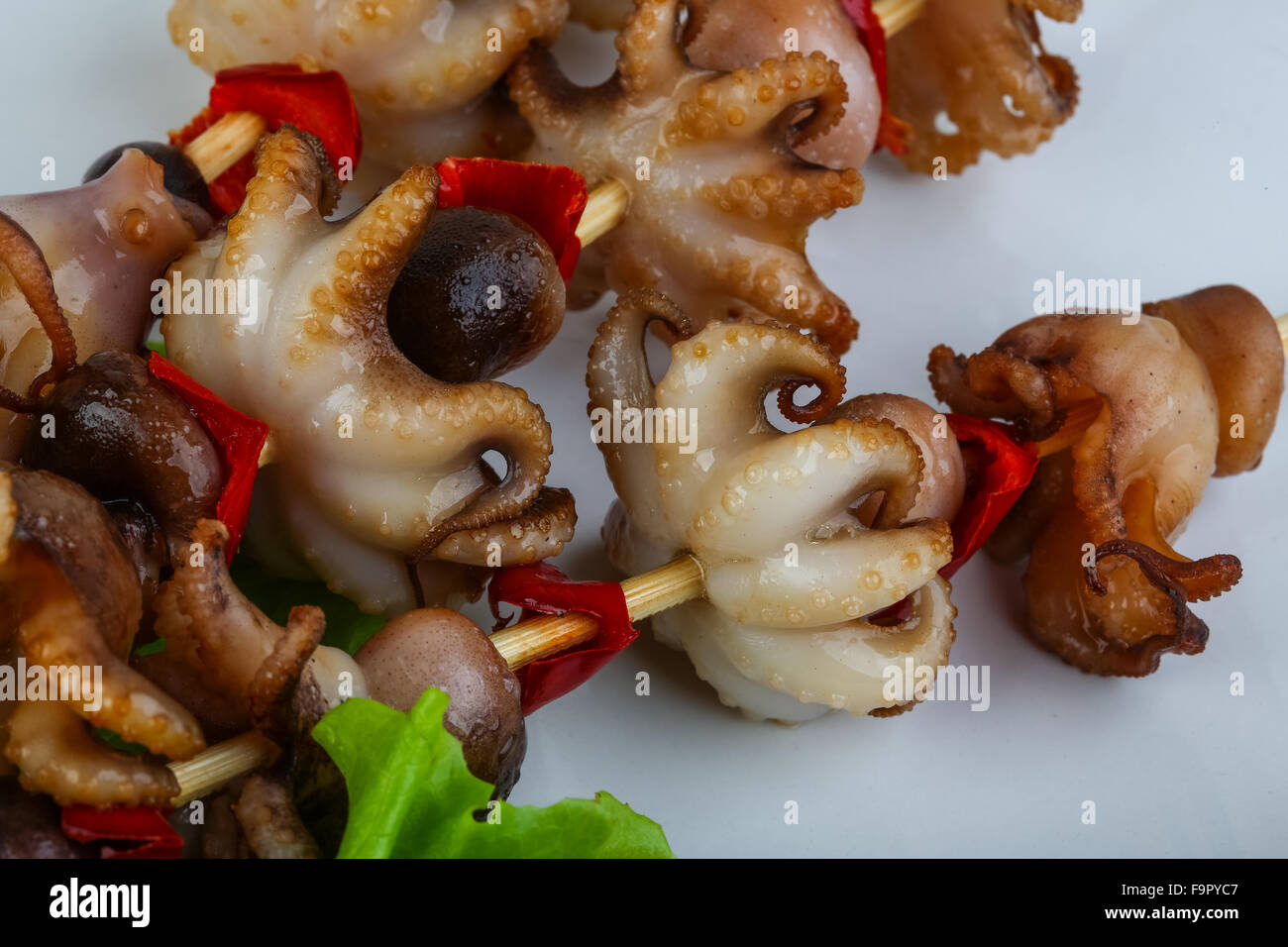 Grilled octopus skewers with red pepper and onion Stock Photo Alamy
