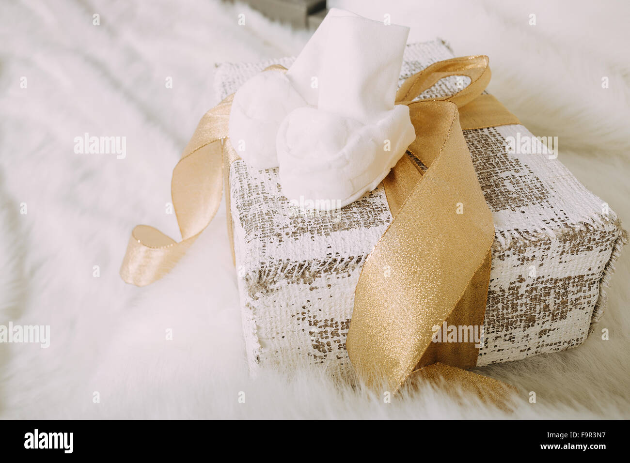 White baby shoes on fluffy background Stock Photo - Alamy