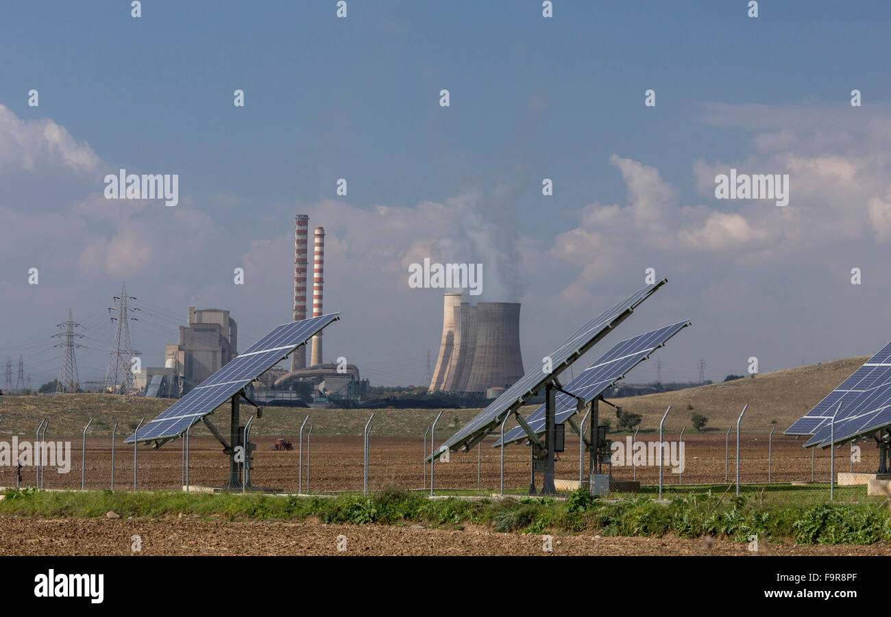 Solar panels and polluting coal-fired (lignite) power station beyond, Aghios Dimitrios, nr. Kozani, North Greece. Largest power Stock Photo