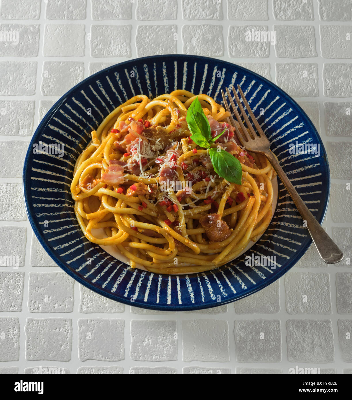 Bucatini all'amatriciana.Pasta with bacon and tomato sauce. Italian food. Stock Photo