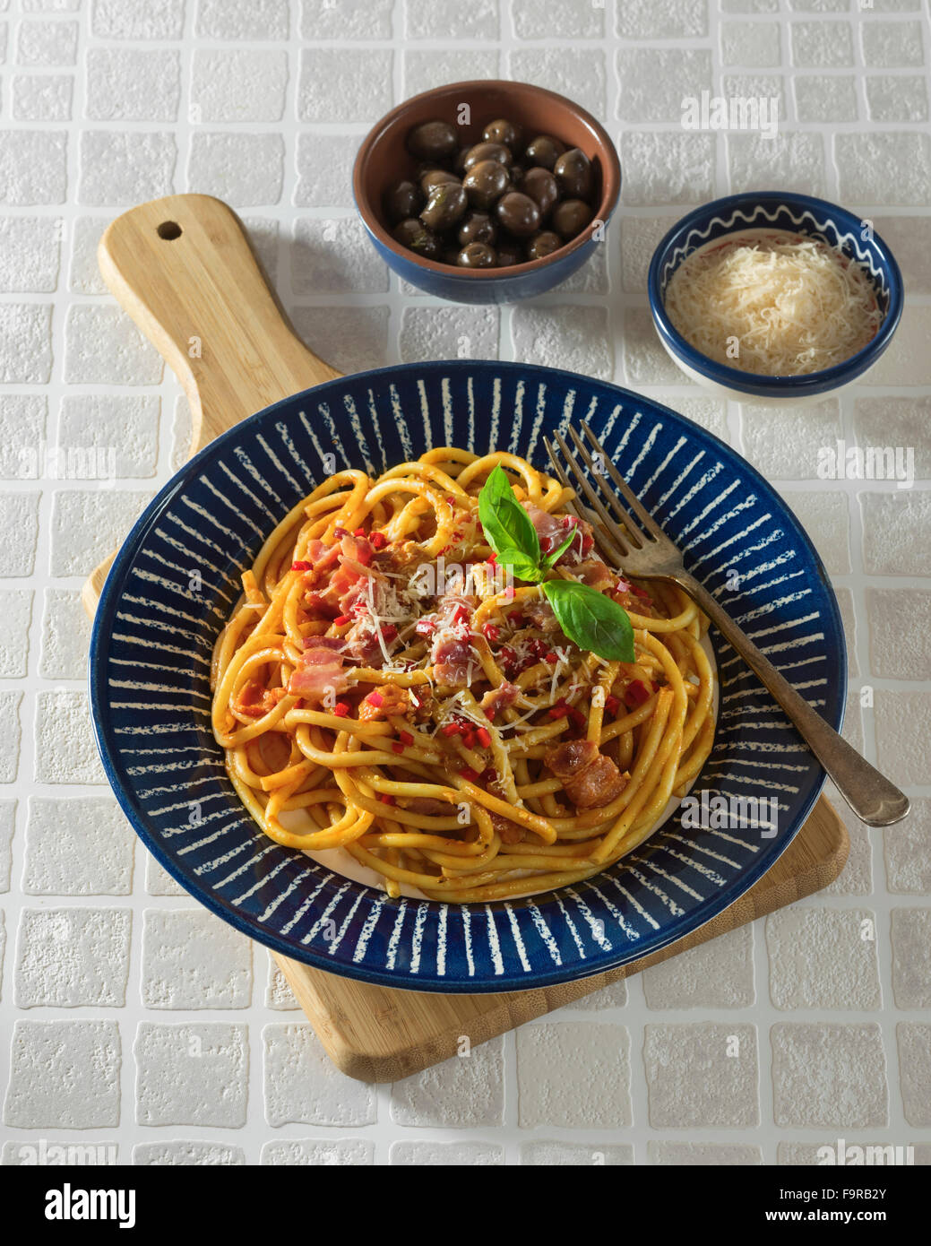 Bucatini all'amatriciana.Pasta with bacon and tomato sauce. Italian food. Stock Photo