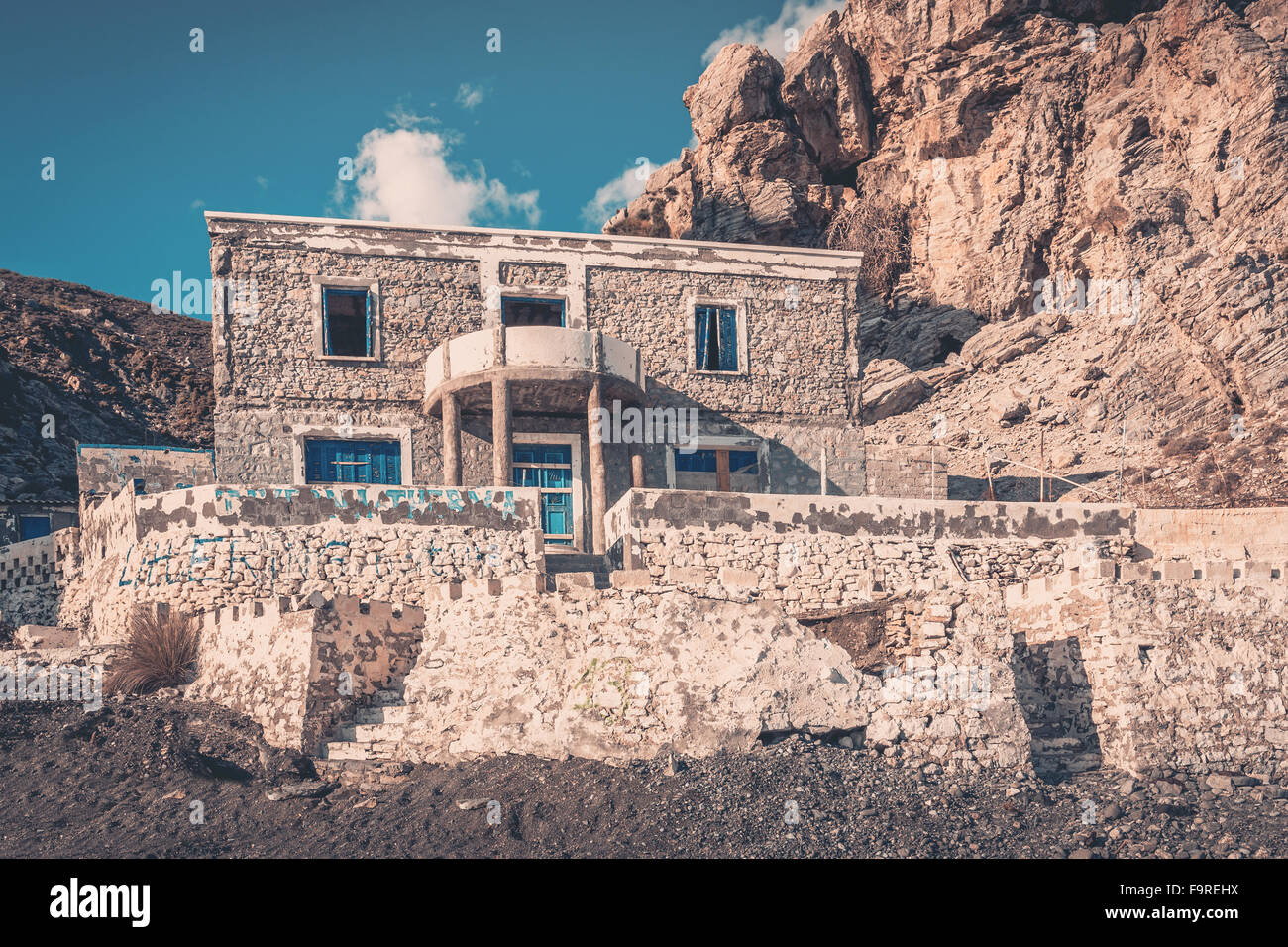 Weathered abandoned house on greek coastline on Kos island Stock Photo