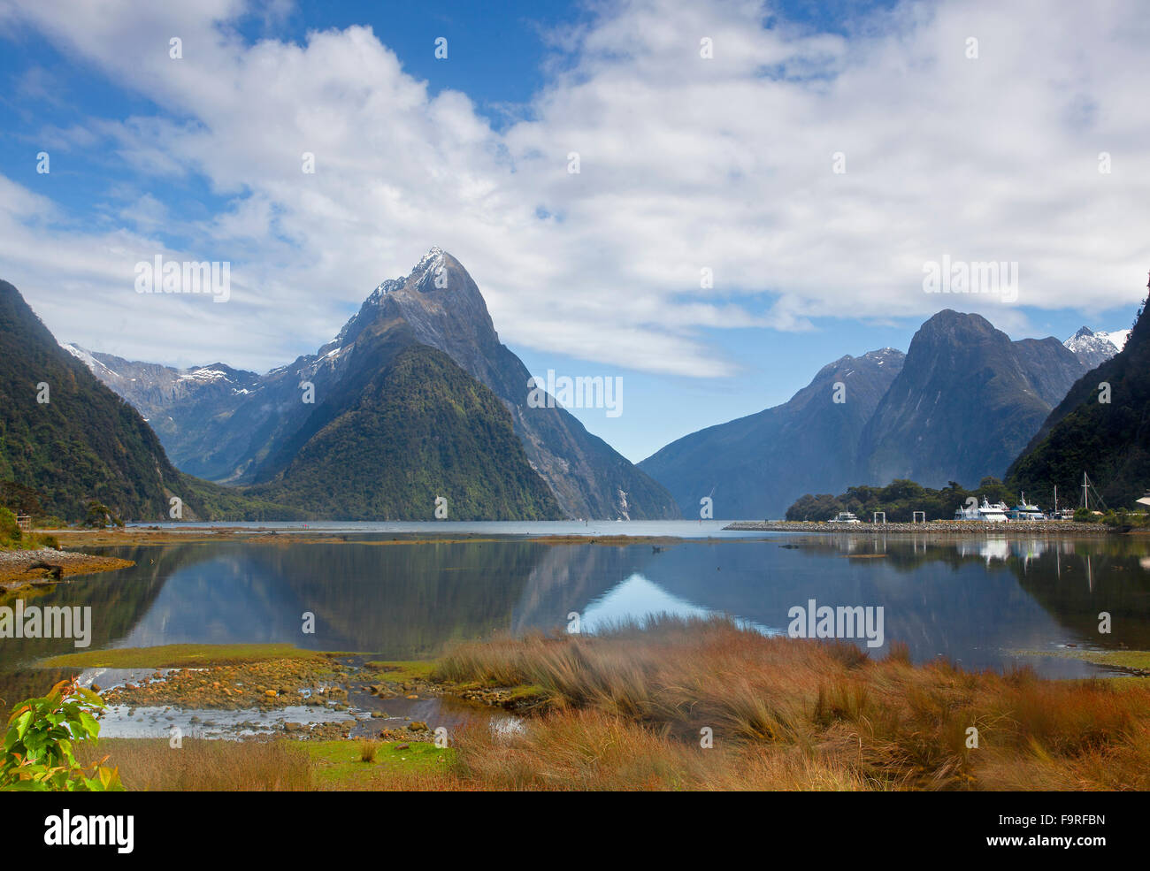 Milford Sound looking northwest from the township. The triangle shape of Mitre Peak is 1,692 m (5,551 ft) above the sea level. Stock Photo