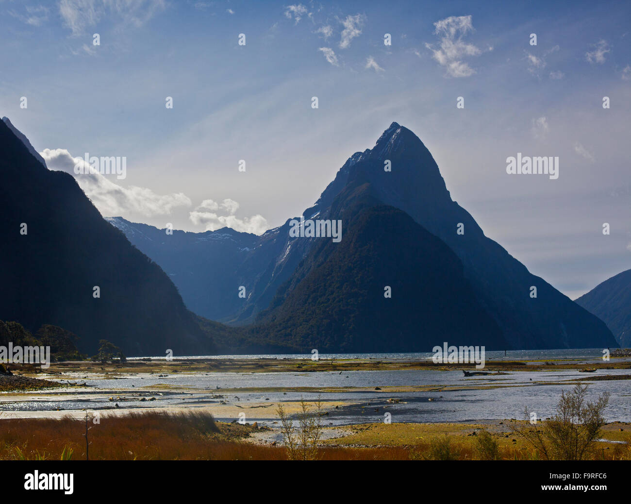 Milford Sound looking northwest from the township. The triangle shape of Mitre Peak is 1,692 m (5,551 ft) above the sea level. Stock Photo