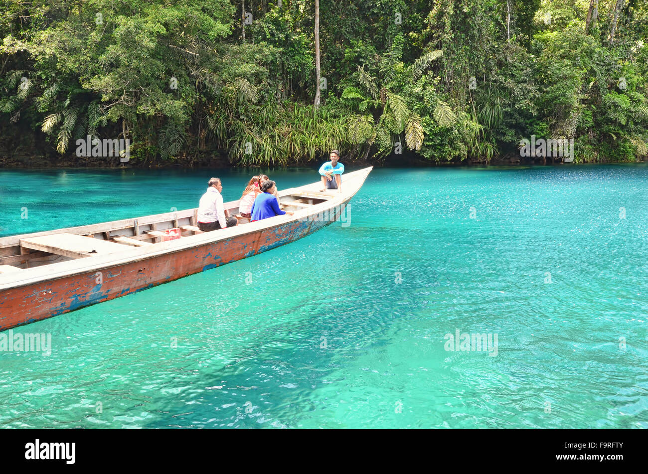 A boat looks like floating on the surface of Labuan Cermin Lake Stock Photo