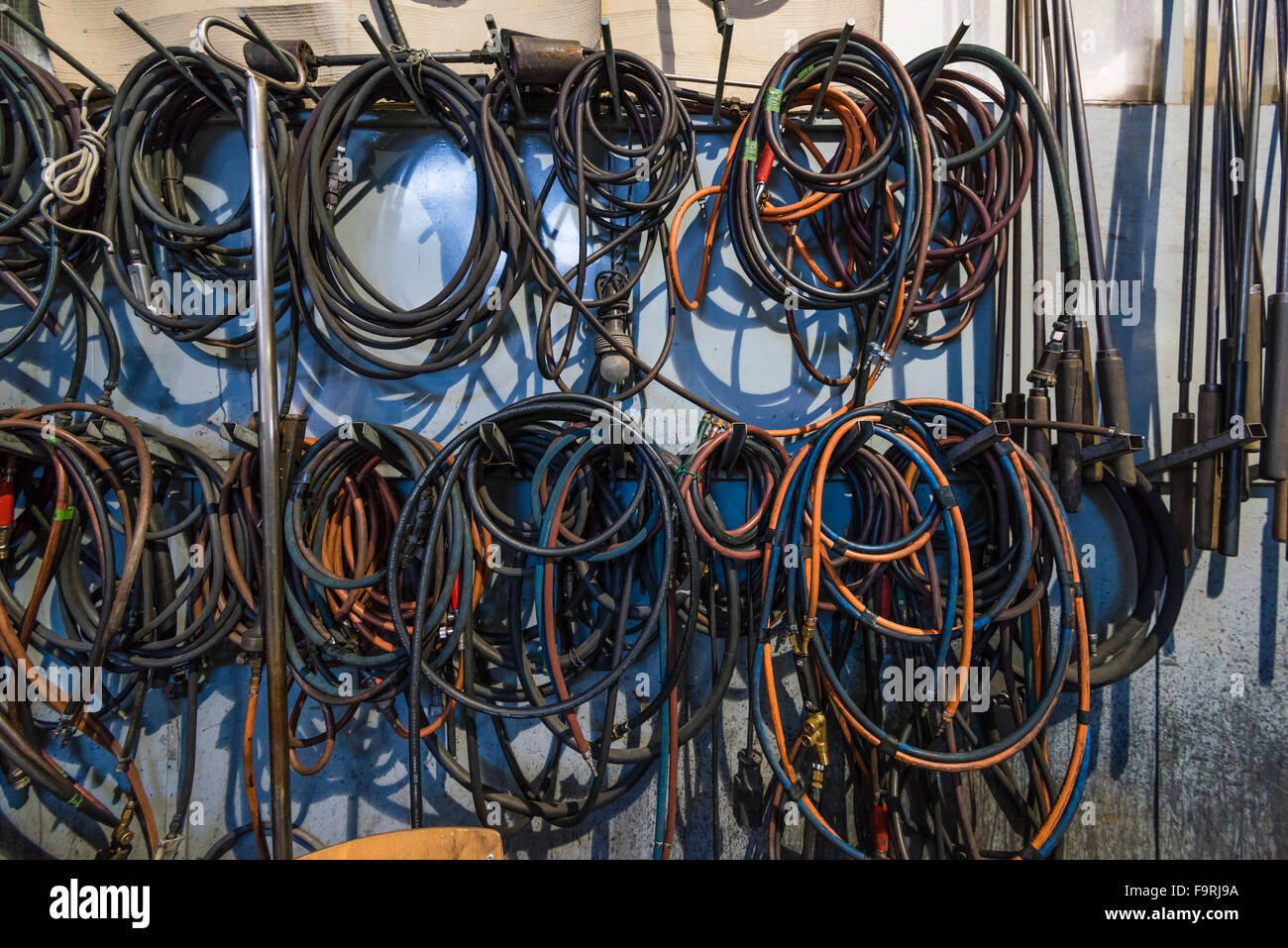 Glassblowing equipment (gas tubes) on the wall of at a glass blowing
