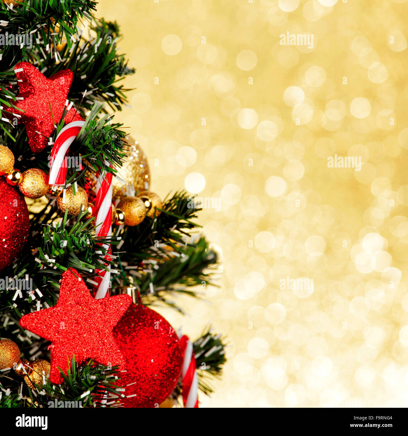 Beautiful decorated christmas tree on golden background Stock Photo Alamy