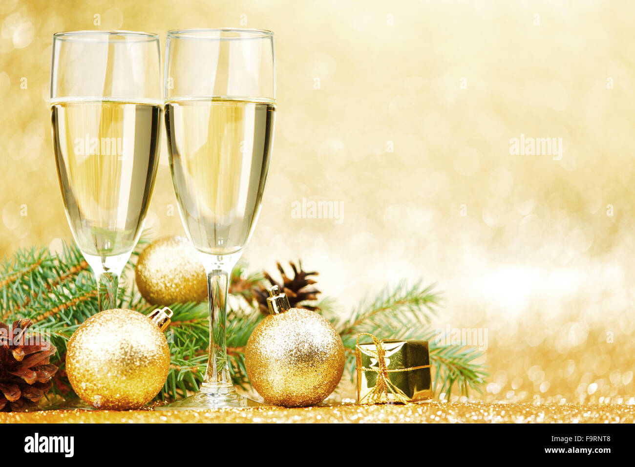 Christmas card with fir branch and decorations on golden gitter ...
